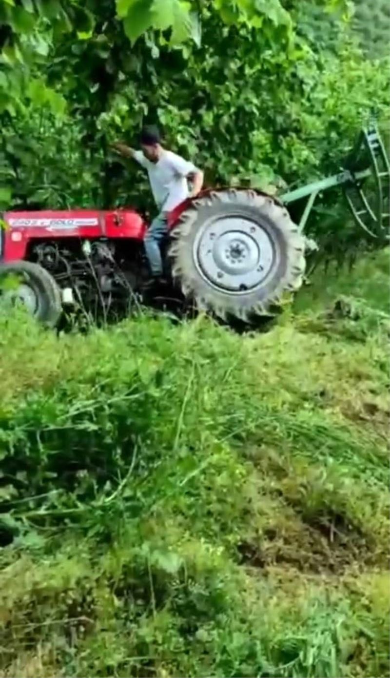 Devrilen traktörden şans eseri kurtuldu
