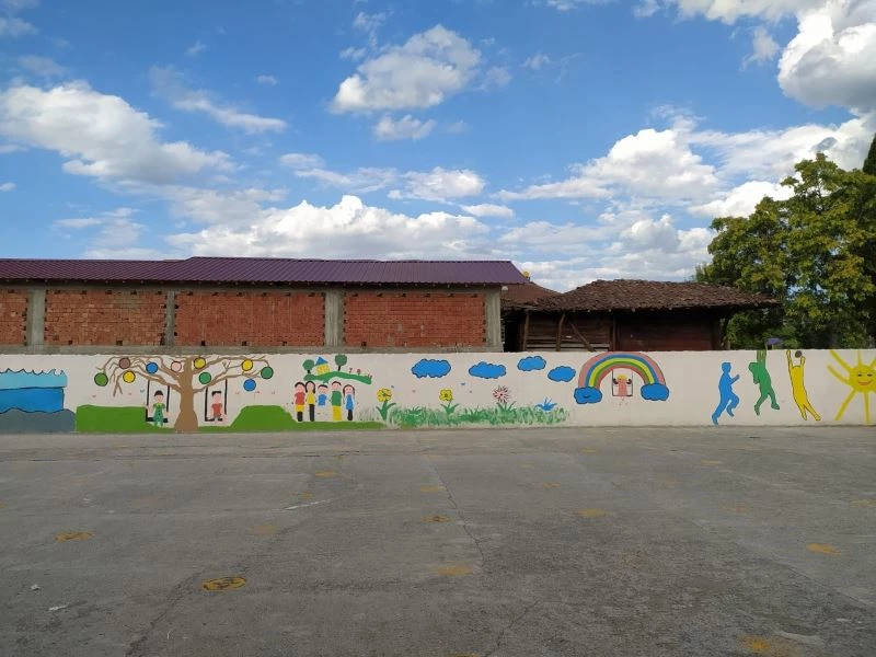 Okul duvarını renklendirdi
