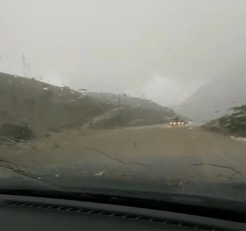 Rizeli sürücü yolun üzerinden akan dereye ve aralıksız yağan doluya rağmen yoluna böyle devam etti
