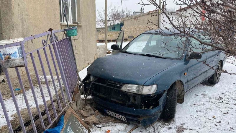 Karlı yolda kayan otomobil evin balkonuna çarparak durabildi
