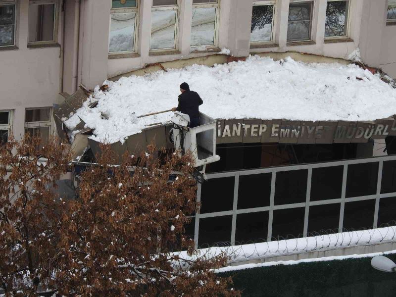 Emniyet müdürlüğünün kapı girişi çatısına düşen kar kütleleri vinç yardımıyla temizleniyor
