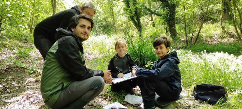 Öğrencilerini ormanda gezdirip ders veriyor
